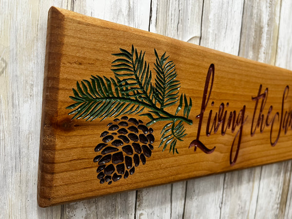Living the Sunriver Life Pine Cone Branch Sign - Carved Cherry Wood