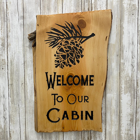 Welcome to Our Cabin Sign - Pinecone Branch - Carved Live Edge Juniper Slab